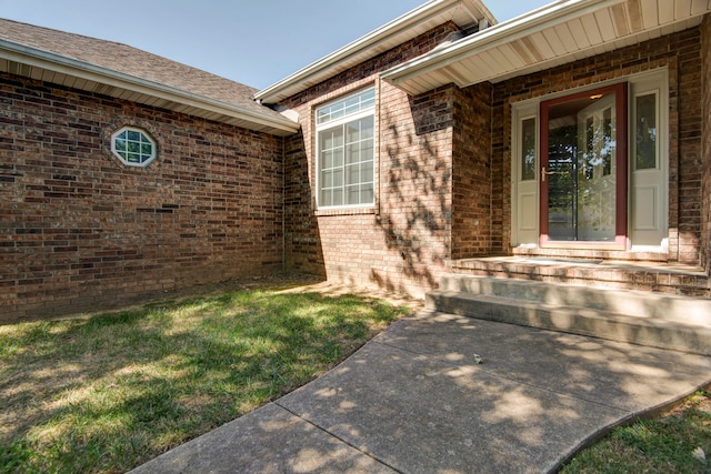 entrance to property with a lawn