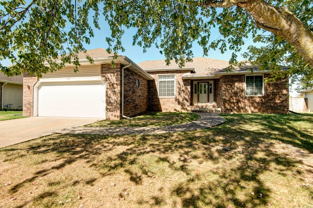 single story home featuring a garage and a front lawn