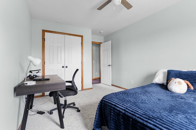 carpeted bedroom with a closet and ceiling fan