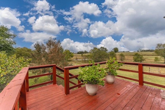 wooden terrace featuring a rural view