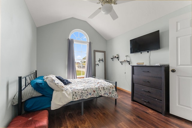 bedroom featuring dark hardwood / wood-style flooring, ceiling fan, and vaulted ceiling