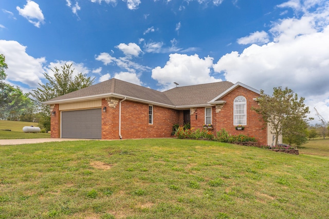 single story home featuring a garage and a front lawn