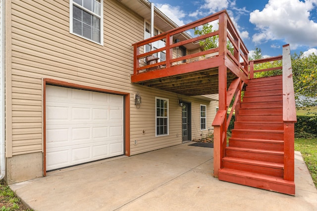 exterior space featuring a garage and a wooden deck