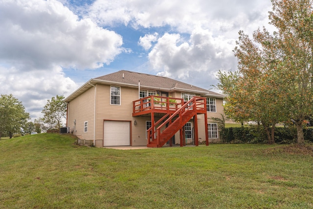 back of house with a deck, a garage, a yard, and central AC unit