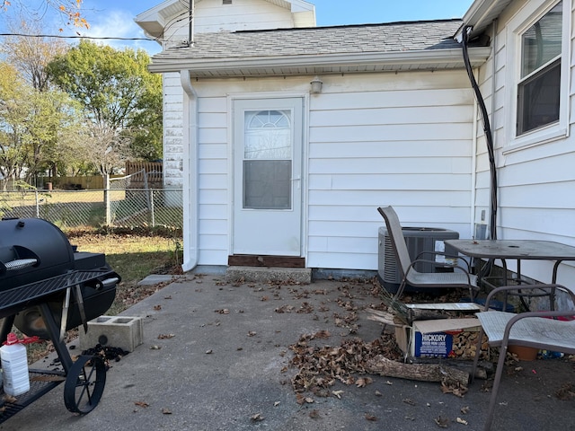 view of patio with central air condition unit and a grill