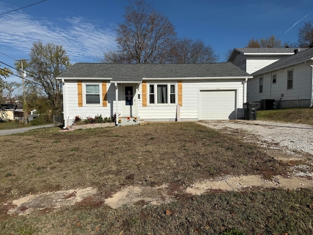 view of front facade featuring central AC unit, a garage, and a front lawn