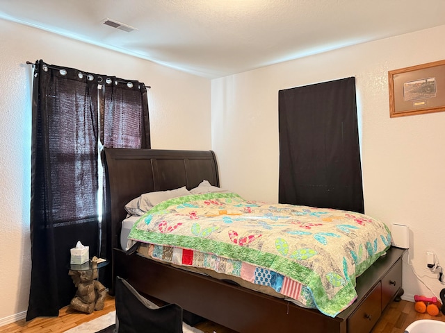 bedroom with wood-type flooring