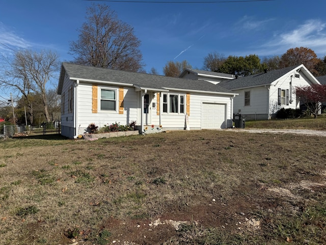 single story home featuring a garage and a front lawn