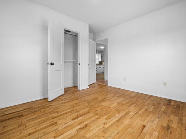 603 E Maupin St, Bolivar, MO 65613 - unfurnished bedroom featuring light wood-type flooring, baseboards, and a closet