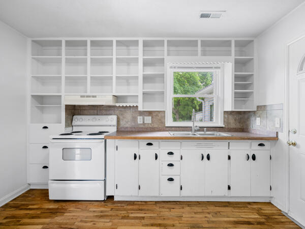603 E Maupin St, Bolivar, MO 65613 - kitchen with open shelves, white electric range oven, a sink, and tasteful backsplash