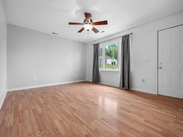 603 E Maupin St, Bolivar, MO 65613 - spare room with light wood finished floors, a ceiling fan, and baseboards
