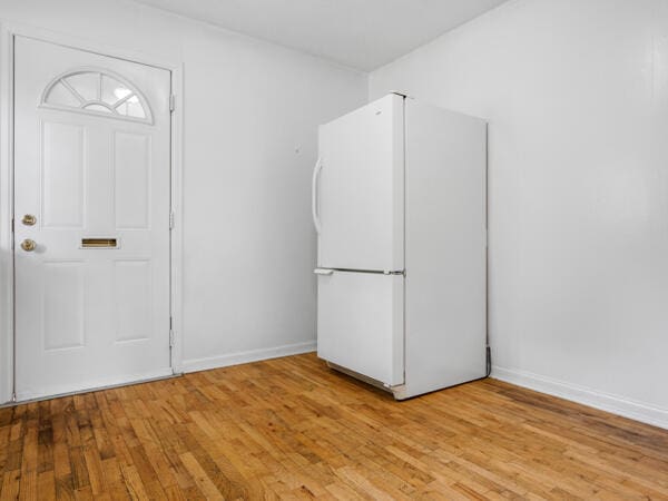 603 E Maupin St, Bolivar, MO 65613 - kitchen with freestanding refrigerator, light wood-style floors, and baseboards