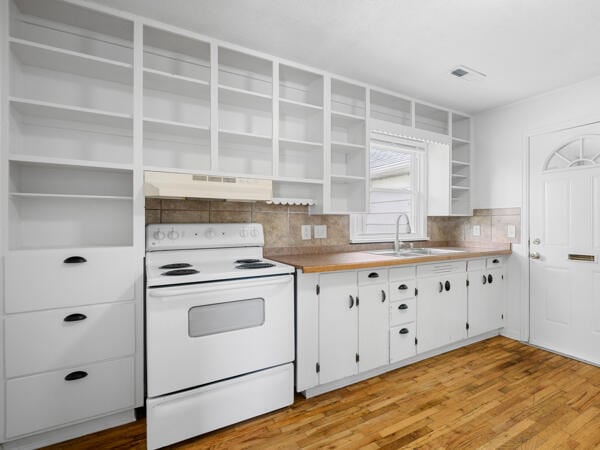 603 E Maupin St, Bolivar, MO 65613 - kitchen featuring white electric range oven, open shelves, under cabinet range hood, white cabinets, and decorative backsplash