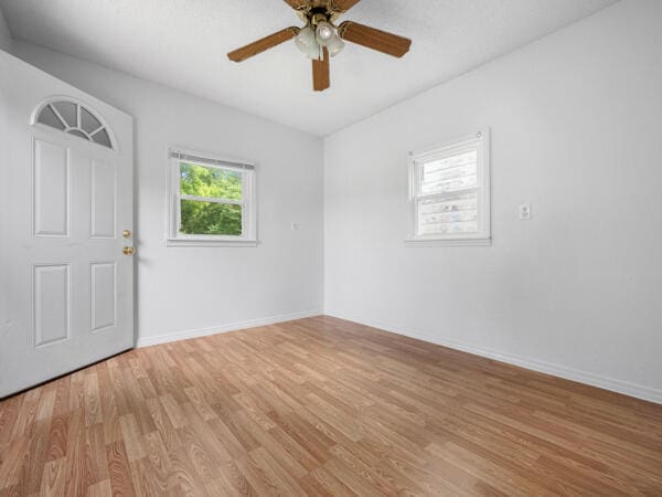 603 E Maupin St, Bolivar, MO 65613 - spare room featuring light wood-style flooring, a ceiling fan, and baseboards