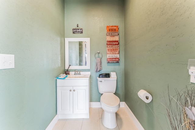 bathroom featuring vanity, tile patterned floors, and toilet