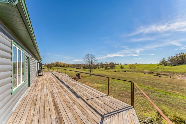 wooden deck with a rural view and a yard