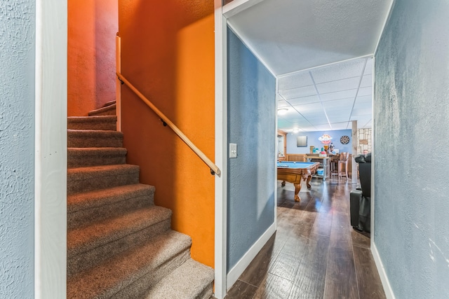 stairway featuring billiards and wood-type flooring