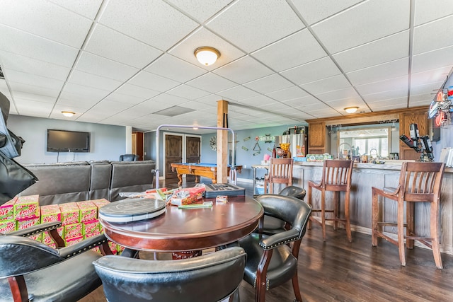 dining room with pool table, dark wood-type flooring, indoor bar, and a drop ceiling