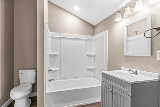 full bathroom featuring hardwood / wood-style floors, vanity, lofted ceiling, toilet, and shower / bathtub combination