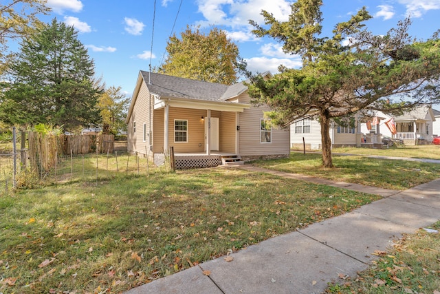 bungalow featuring a porch and a front lawn