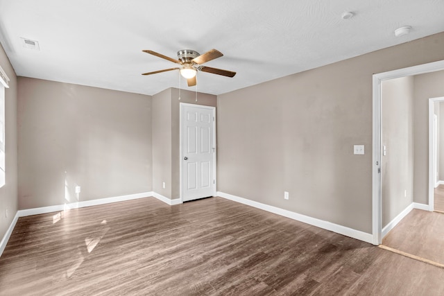 spare room with hardwood / wood-style floors and ceiling fan