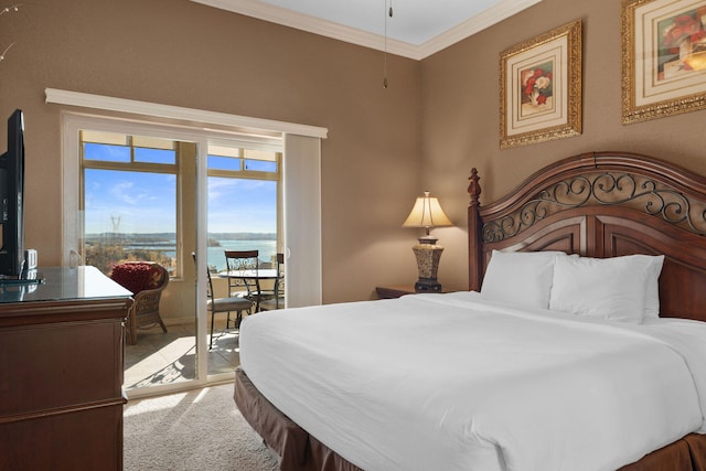 carpeted bedroom featuring access to exterior, a water view, and crown molding