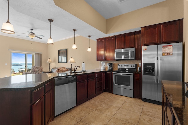 kitchen with stainless steel appliances, pendant lighting, a water view, and kitchen peninsula