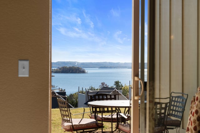 balcony featuring a water and mountain view