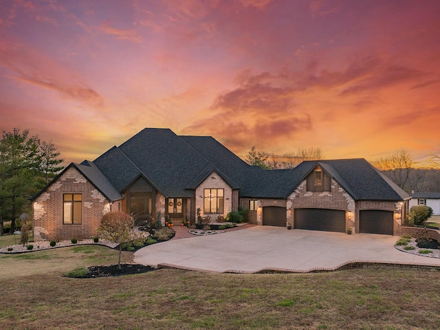 view of front of property featuring a garage and a yard