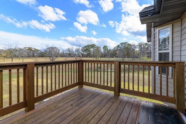 wooden terrace with a lawn