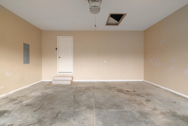 garage with a garage door opener and electric panel