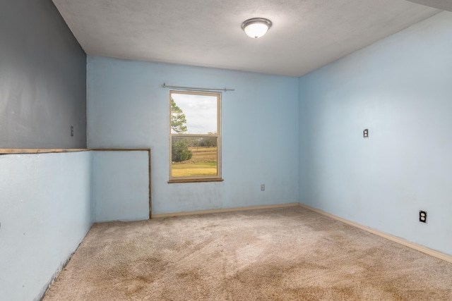 unfurnished room with a textured ceiling and carpet floors