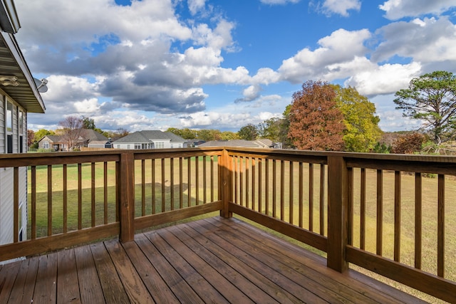 wooden deck featuring a yard