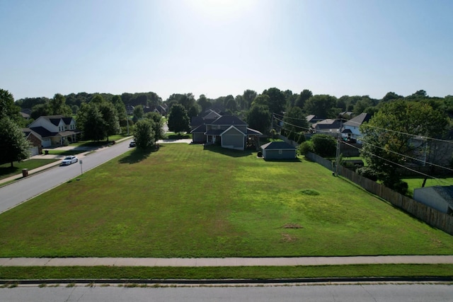 view of property's community featuring a yard