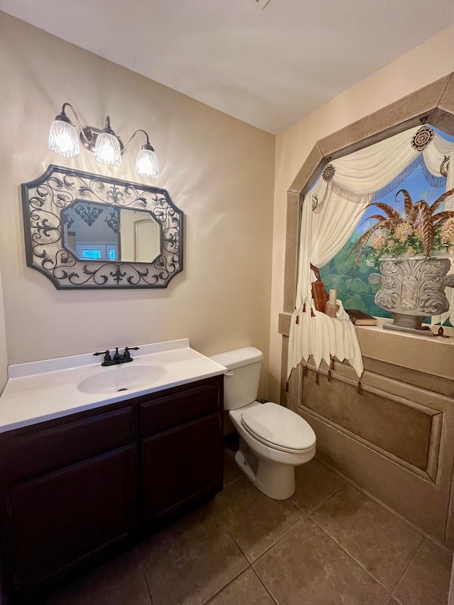 bathroom featuring tile patterned floors, vanity, and toilet