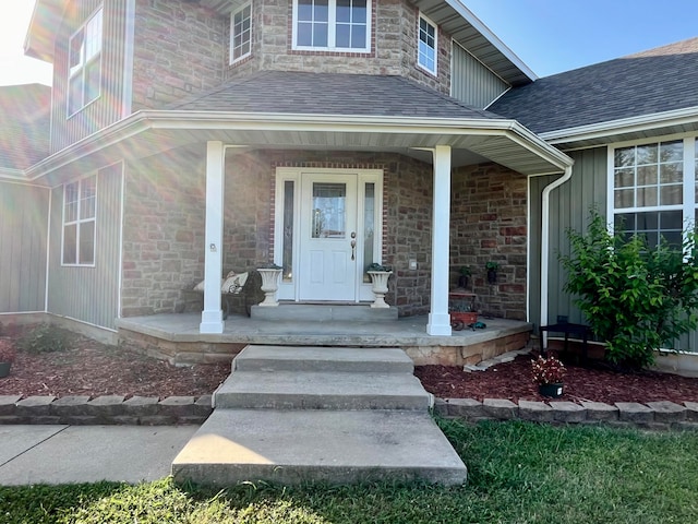 view of exterior entry with a porch