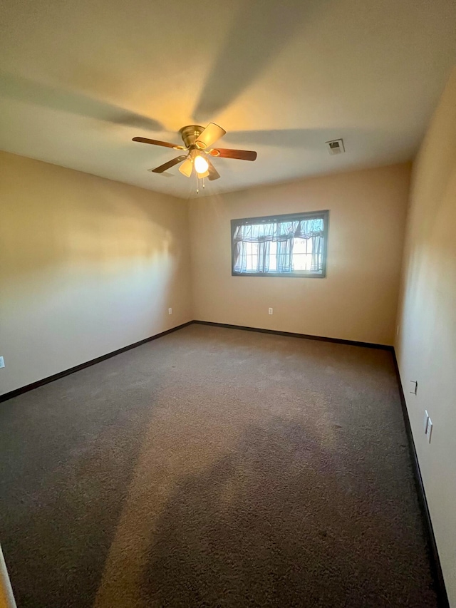 spare room featuring ceiling fan and carpet