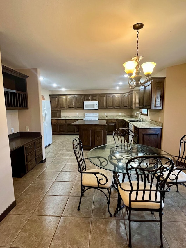 tiled dining area featuring sink and a chandelier