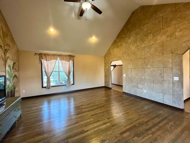 unfurnished living room featuring ceiling fan, dark wood-type flooring, and vaulted ceiling