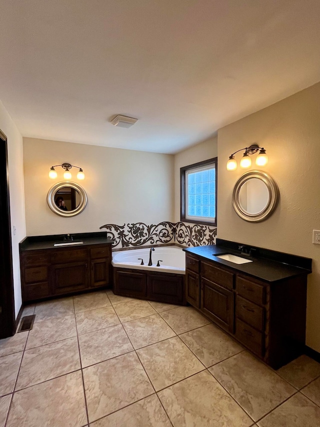 bathroom featuring tile patterned floors, vanity, and a bathing tub