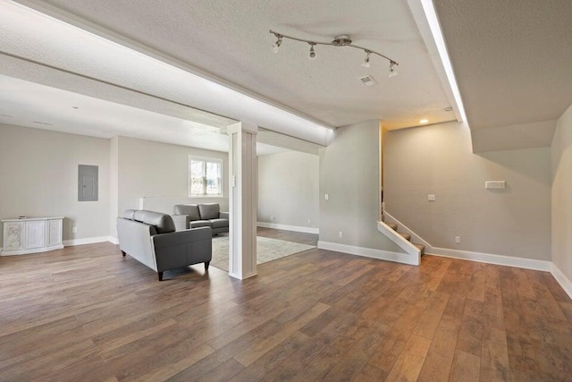 living room with electric panel, wood-type flooring, and a textured ceiling