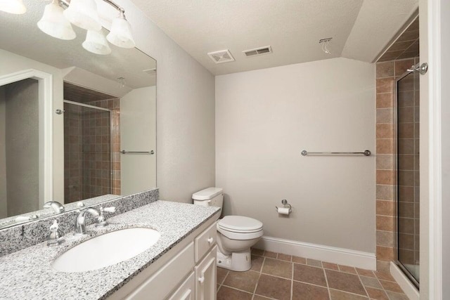 bathroom with toilet, a textured ceiling, tile patterned flooring, and a shower with shower door