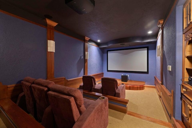 carpeted home theater room with ornate columns