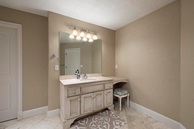 bathroom with vanity and a textured ceiling