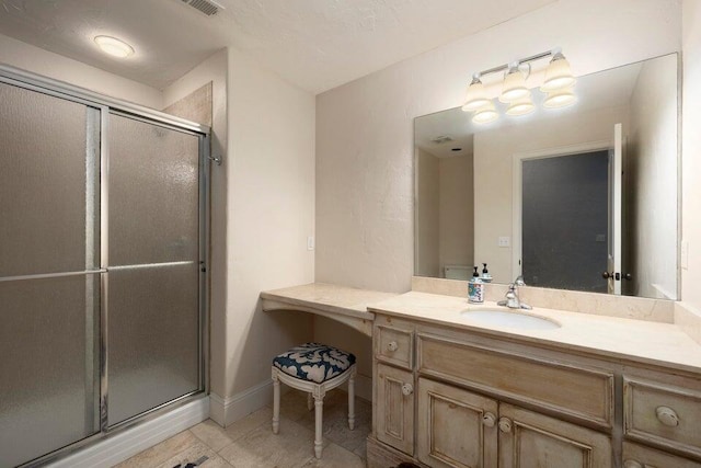 bathroom with tile patterned flooring, vanity, and a shower with door