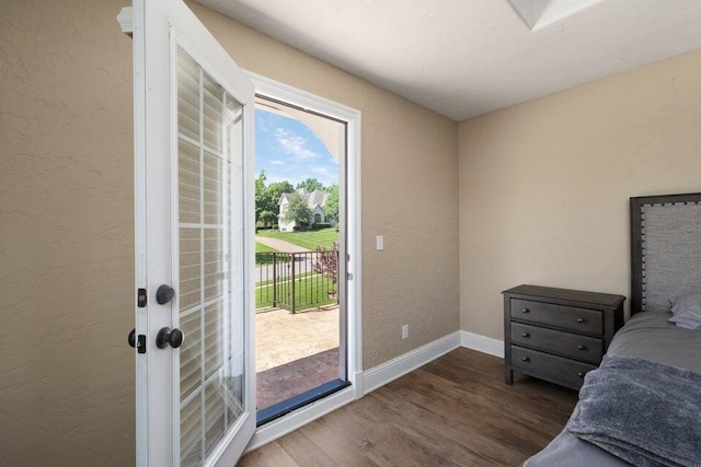 bedroom with dark wood-type flooring and access to exterior