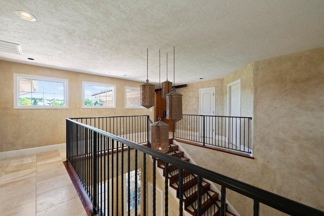 hallway featuring a textured ceiling