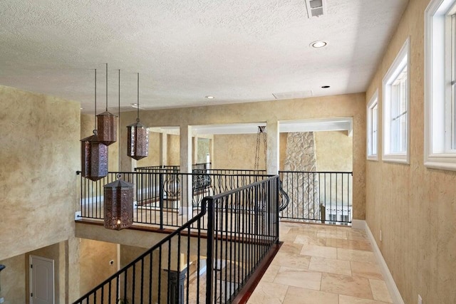 hallway with a textured ceiling