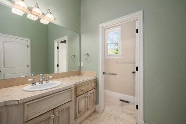 bathroom featuring tile patterned flooring and vanity