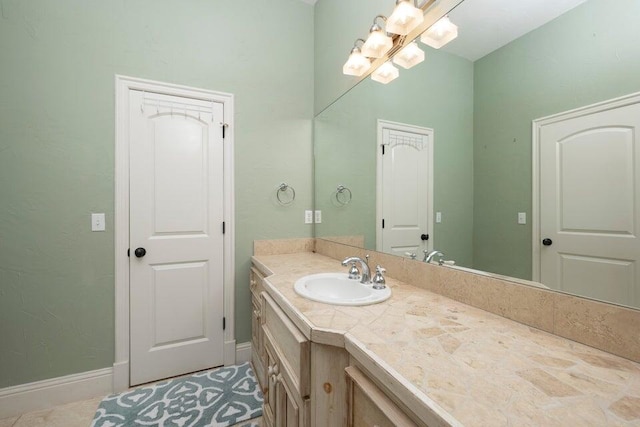 bathroom featuring tile patterned flooring and vanity